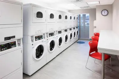a laundry room with a row of washers and dryers at Residence Inn by Marriott Near Universal Orlando in Orlando