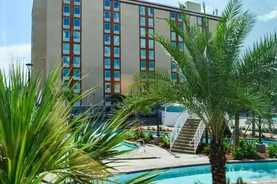 a palm tree in front of a building at Radisson Hotel Orlando Lake Buena Vista South in Kissimmee