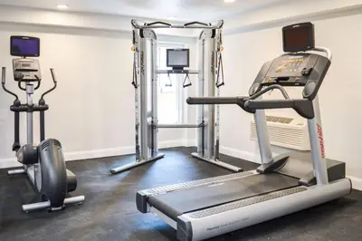 a gym with a treadmill and a simulator at Radisson Hotel Orlando Lake Buena Vista South in Kissimmee