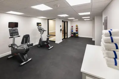a gym with two treadmills and exercise bikes at Radisson Hotel Orlando Lake Buena Vista South in Kissimmee