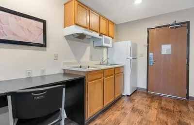 a small kitchen with a sink and a refrigerator at Extended Stay America Select Suites - Orlando - South in Orlando