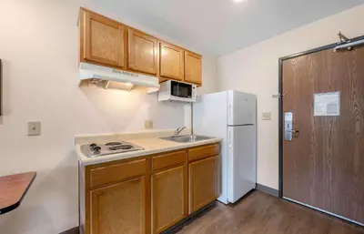 a small kitchen with a sink and a refrigerator at Extended Stay America Select Suites - Orlando - East in Orlando