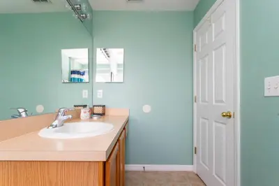 a bathroom with a sink and a mirror at 7 Bedroom Mansion Near Disney in Kissimmee