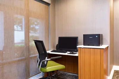 an office with a desk with a computer and a chair at SpringHill Suites Orlando Altamonte Springs/Maitland in Orlando