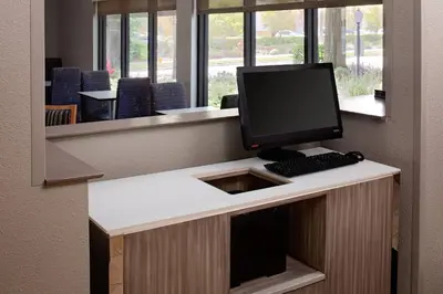 a desk with a computer monitor and a keyboard at Residence Inn by Marriott Orlando Altamonte Springs Maitland in Orlando