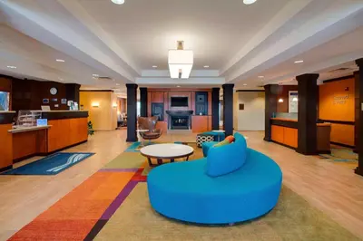 a living room with a blue couch and a table at Fairfield Inn & Suites by Marriott Clermont in Clermont