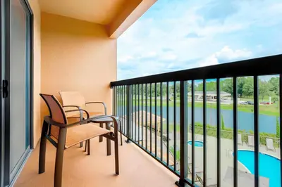 a balcony with a table and chairs and a large window at Courtyard by Marriott Orlando Lake Mary North in Lake Mary