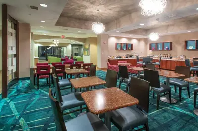 a restaurant with tables and chairs and a cafeteria at SpringHill Suites by Marriott Orlando North-Sanford in Sanford