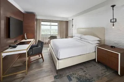 a hotel room with a bed and a desk and a television at Orlando Marriott Lake Mary in Lake Mary