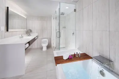 a bathroom with a tub and a sink and a toilet at Orlando Marriott Lake Mary in Lake Mary