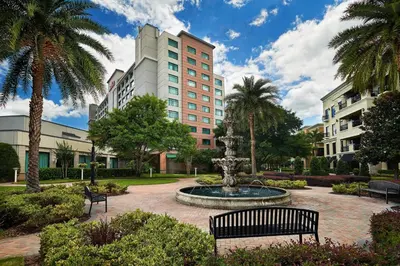 a park with a fountain in front of a building at Orlando Marriott Lake Mary in Lake Mary