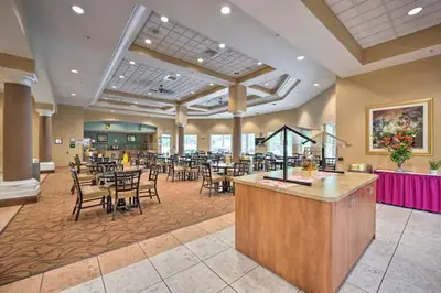 a restaurant with tables and chairs and a bar at Lake Buenavista Apartments close to Disney in Orlando