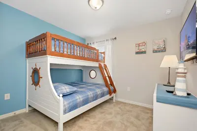 a childs bedroom with a bunk bed with a ladder at Four Bedrooms Townhome 5108K in Kissimmee