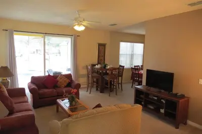 a living room with a couch and a tv at Formosa Garden Pool Home in Kissimmee