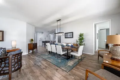 a dining room and living room with a table and chairs at La Vista Lakeview Condo in Orlando