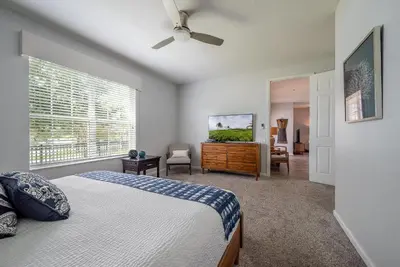 a bedroom with a bed and a dresser and a window at La Vista Lakeview Condo in Orlando
