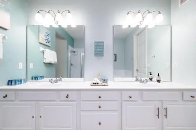 a bathroom with two sinks and a large mirror at La Vista Lakeview Condo in Orlando