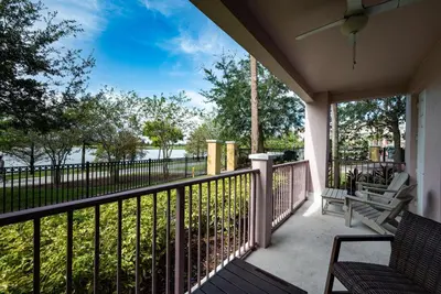 a porch with chairs and a view of the water at La Vista Lakeview Condo in Orlando
