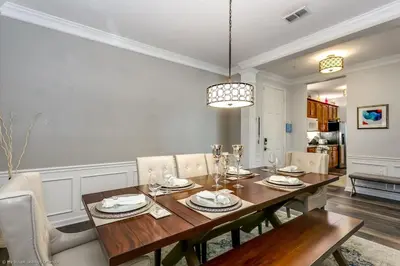 a dining room with a wooden table and chairs at Miranda's Gem Condo in Orlando