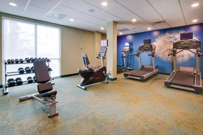 a gym with treadmills and exercise machines in a room at SpringHill Suites by Marriott Orlando Lake Buena Vista South in Kissimmee