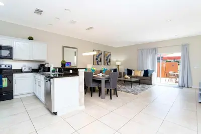 a kitchen and living room with a table and a dining room at Three Bedrooms Townhome 3012 in Kissimmee