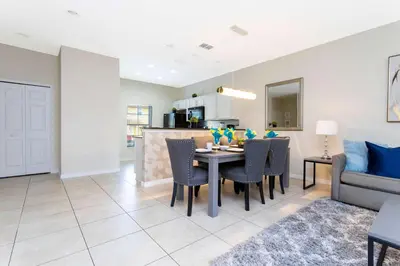 a kitchen and living room with a table and chairs at Three Bedrooms Townhome 3012 in Kissimmee