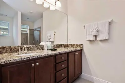 a bathroom with two sinks and a large mirror at DREAM HOUSE, ECOLAB Sanitzed NEAR DISNEY, POOL FENCE in Orlando
