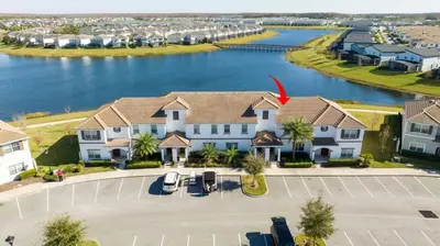 an aerial view of a large house with a lake at Four Bedrooms TownHome 4861 in Kissimmee