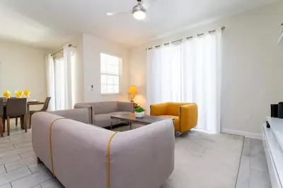 a living room with a couch and a table at Four Bedrooms TownHome 4861 in Kissimmee