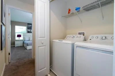 a laundry room with a washing machine and a sink at Four Bedrooms TownHome 4861 in Kissimmee