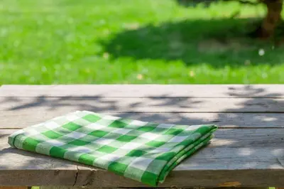 a green and white pillow sitting on a wooden table at Extended Stay America Suites - Orlando - Southpark - Commodity Circle in Orlando