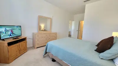 a bedroom with a bed and a flat screen tv at Windsor Palm Condo #213421 in Kissimmee