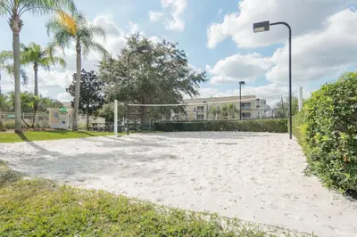 a volleyball court with a net on a beach at Windsor Palm Condo #213421 in Kissimmee