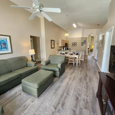 a living room with couches and a dining room at Lake Berkley Home #213517 in Kissimmee