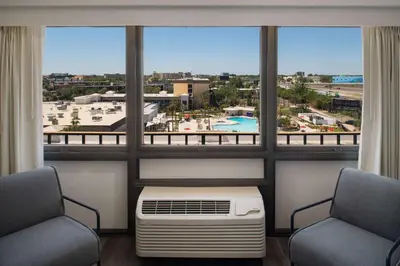 a room with two chairs and a large window at Wyndham I-Drive Avanti Resort & Conference Center in Orlando