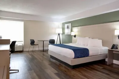 a hotel room with a bed and a table at Wyndham I-Drive Avanti Resort & Conference Center in Orlando