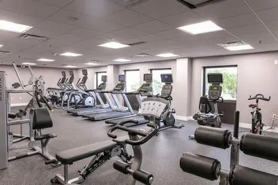 a gym with rows of exercise bikes and treadmills at Wyndham I-Drive Avanti Resort & Conference Center in Orlando