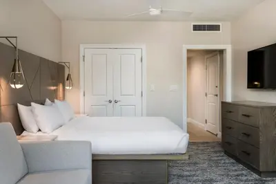 a bedroom with a white bed and a couch at Marriott's Lakeshore Reserve in Orlando