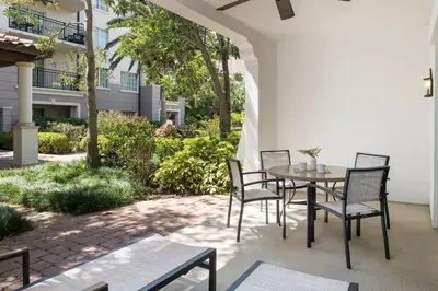 a patio with a table and chairs and trees at Marriott's Lakeshore Reserve in Orlando