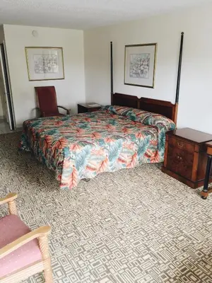 a hotel room with a bed and a table and a chair at The keys in Kissimmee