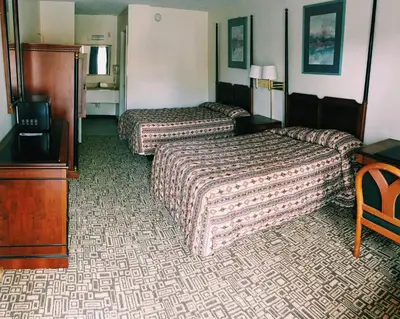 a hotel room with two beds and a television at The keys in Kissimmee