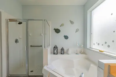 a white bathroom with a shower and a tub at 5-Star Resort Villa with Private Pool, Minutes from Disney in Kissimmee