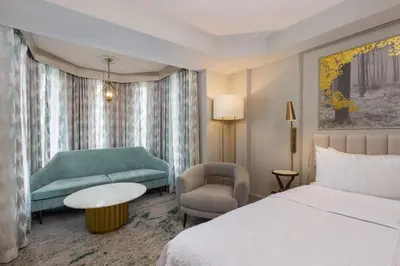 a hotel room with a bed and a couch at Castle Hotel, Autograph Collection in Orlando