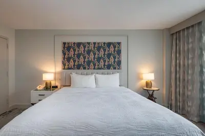 a bedroom with a large white bed with two lamps at Castle Hotel, Autograph Collection in Orlando