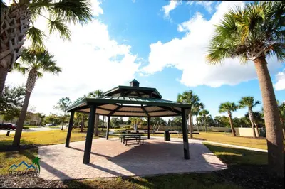 a picnic shelter in a park with palm trees at Four Bedrooms TownHome 5122 in Kissimmee