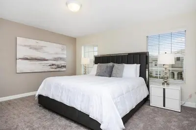 a bedroom with a large white bed and a window at Four Bedrooms w/ Pool TownHome 4841 in Kissimmee