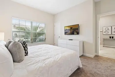 a white bedroom with a large bed and a window at Four Bedrooms w/ Pool TownHome 4841 in Kissimmee