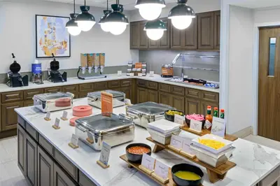 a kitchen with a counter with some food on it at Homewood Suites by Hilton Orlando-UCF Area in Orlando