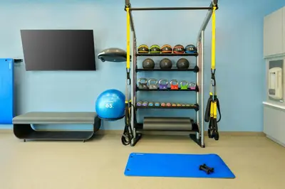 a room with a gym with a rack of balls at Homewood Suites by Hilton Orlando-UCF Area in Orlando