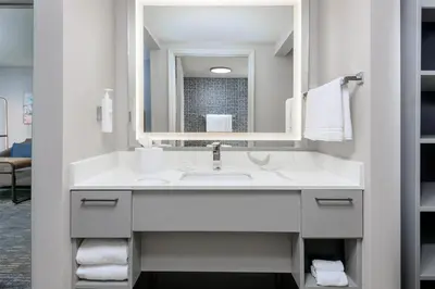 a bathroom with a sink and a mirror at Homewood Suites by Hilton Orlando-UCF Area in Orlando